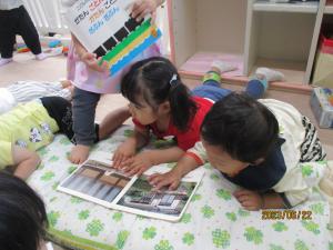 寝転んで絵本を見る　1歳児