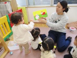 クリスマスの絵本を見る　0歳児